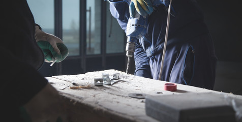 Master drills a hole in a metal. Industry