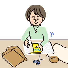 商品をエアーキャップで梱包する女性