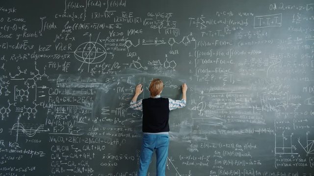 Crazy scientist is writing formulas on chalkboard then shouting beating board feeling angry because of science problem. Emotions, people and lifestyle concept.