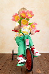 Funny child holding bouquet of flowers