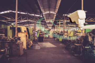 Technician installation CCTV  infrared camera technology 4.0 by screwdriver for look security area of work in construe worker show signage with factory work background.