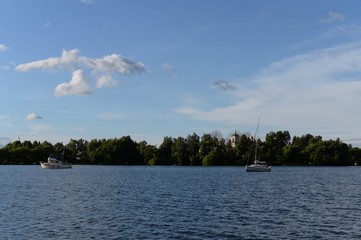 Fototapeta na wymiar View of the village of Ostashkovo from the Klyazma reservoir of the Moscow canal
