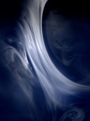 The form that smoke creates floats in the light