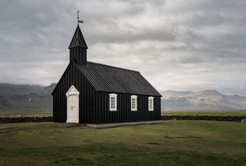 Fototapeta premium Famous black church in Budir, Iceland on a cloudy day