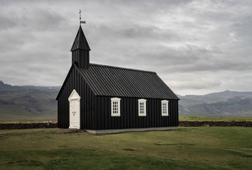 Fototapeta na wymiar Famous black church in Budir, Iceland on a cloudy day