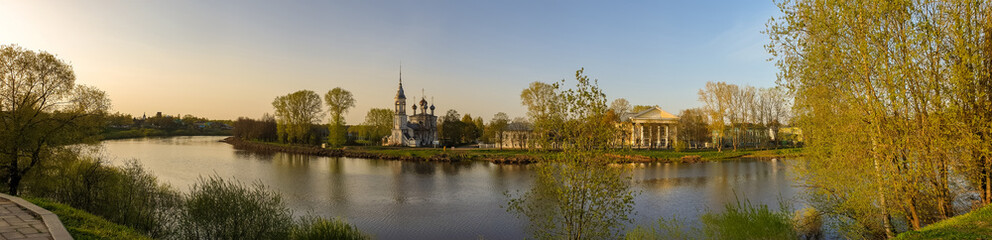 Fototapeta na wymiar Vologda. Beautiful spring day on the river Bank. Panorama. Church Of The Meeting Of The Lord. 18th century.