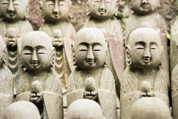 Photograph of several small buddha statues in a row