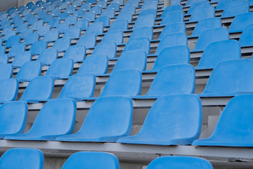 Fototapeta premium Seats in the stadium-background. auditorium-stands. Rows of chairs in an open-air stadium. Spectator seats.