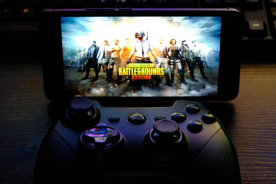 Kostanay, Kazakhstan, February 12, 2020.Joystick and mobile phone with the logo of the popular game Playerunknown's Battlegrounds abbreviated PUBG.