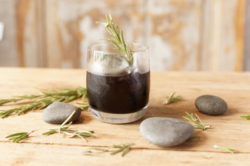 Black cocktail on wooden table