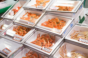 Photograph of a counter with crab boxes for sale