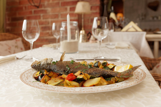 Grilled sea bass on restaurant table