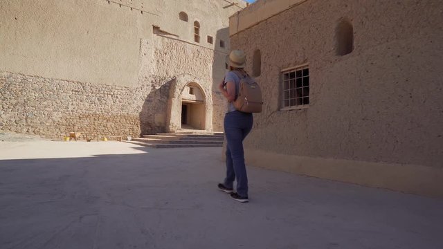 Young Foreign Female Tourist Visiting Ancient Bahla Fort in Oman