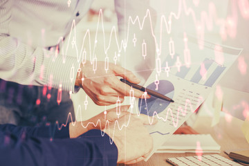 Financial trading graph double exposure with man desktop background.