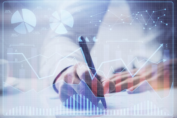 Financial trading graph multi exposure with man desktop background.