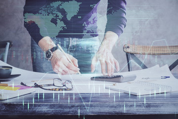 Multi exposure of man standing and planing investment with stock market forex chart.