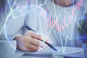 Forex chart displayed on woman's hand taking notes background. Concept of research. Multi exposure