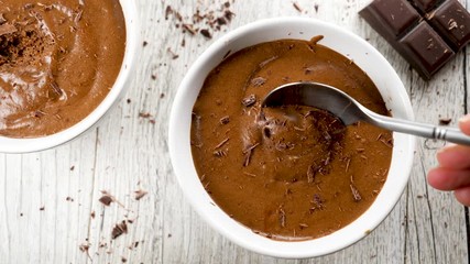 chocolate mousse in bowl- woman eating chocolate mousse, slow motion