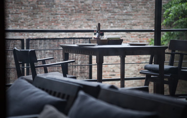 Rustic Indoor Wooden Dining Table, Crockery, Cutlery and Napkin Setting. Hotel Dining Venue, Food...