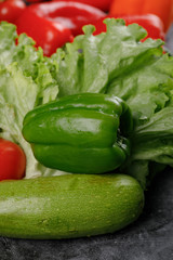 Green zucchini, pepper and lettuce leaves.