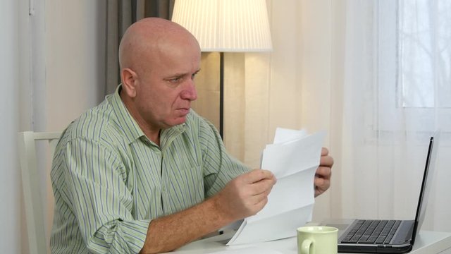 Angry  Businessman Looking Nervous and Disappointed to Invoices, Taxes, and Payments