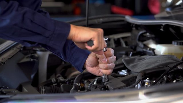 mechanic hand using wrench to repair engine, car service
