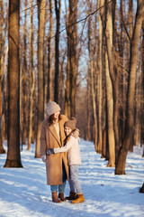 Fototapeta na wymiar Mother and daughter hug in winter