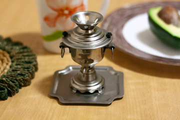 A small decorative vintage samovar on the table