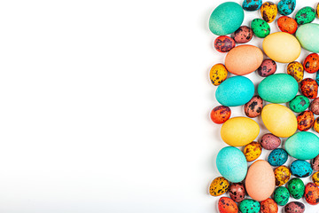Stylish background with colorful quail, easter eggs with copy space for text isolated on white background. Flat lay, top view, mockup, overhead, template
