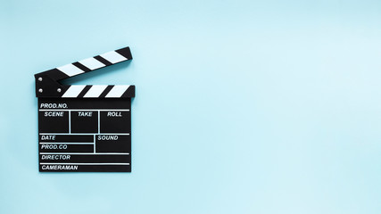 Movie clapper on blue background with copy space