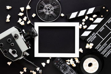 Movie elements on black background with empty frame - obrazy, fototapety, plakaty
