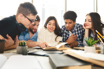 Preparing for exams together. Students studying in library