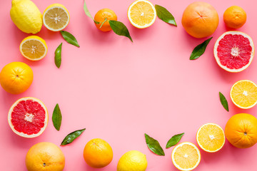 Citrus fruits - lemons, grapefruits - on pink background mockup, frame top-down copy space