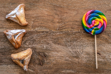 Hamantashen for jewish holiday Purim on wooden background. Top view. Copy space.