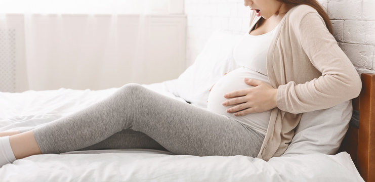 Pregnant woman suffering from contractions at home