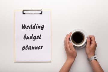 Bride drinking coffee and planning future wedding budget