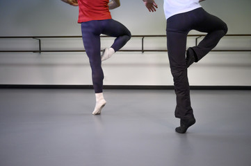 Young man and boy practicing ballet in the dance studio
