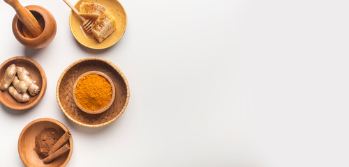 Healthy turmeric spice with, ginger and honey on white