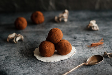 Chocolate homemade truffles. Tasty sweets on the table. Cocoa sprinkled sweets