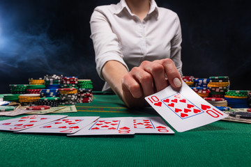 Distribution of croupier, or dealer of cards in a casino, a successful combination. Poker game in a casino in Las Vegas. Gaming business