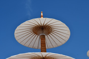 White paper parasol and blue sky.