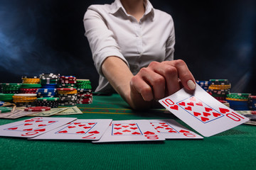 Distribution of croupier, or dealer of cards in a casino, a successful combination. Poker game in a...