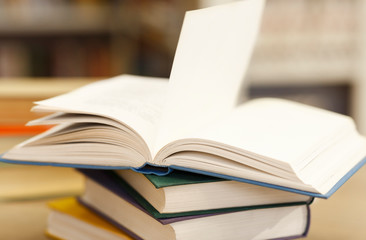 Open book lying on a stack of manuals