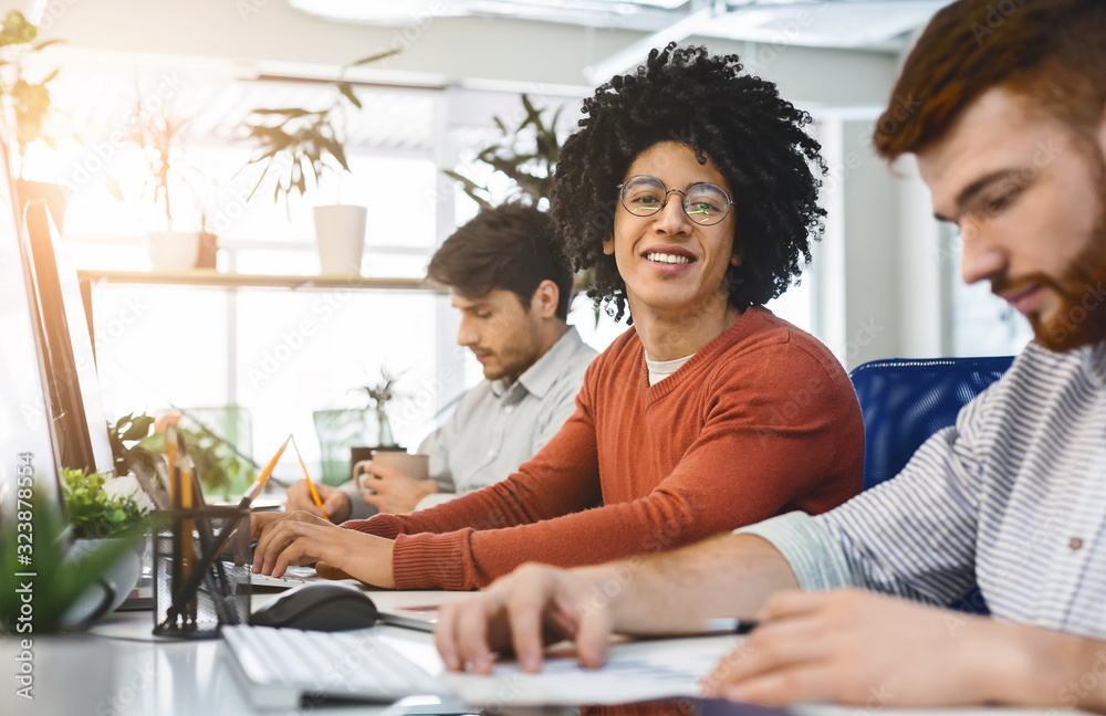 Poster happy mixed race guy working on project with colleagues