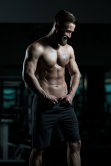 Fototapeta na wymiar Bodybuilder Performing Most Muscular Pose