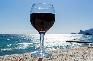 A glass of wine on the background of the sea.