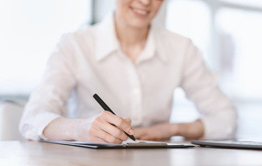 Lady Writing Short Account Of Career Sitting At Workplace, Cropped