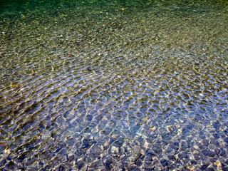 water, waves, light in water, refraction of light in water, light waves on the sandy bottom, sun...