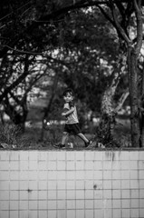 happy young boy playing outdoors in the park