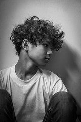 scared and alone, young Asian child who is at high risk of being bullied, trafficked and abused, selective focus